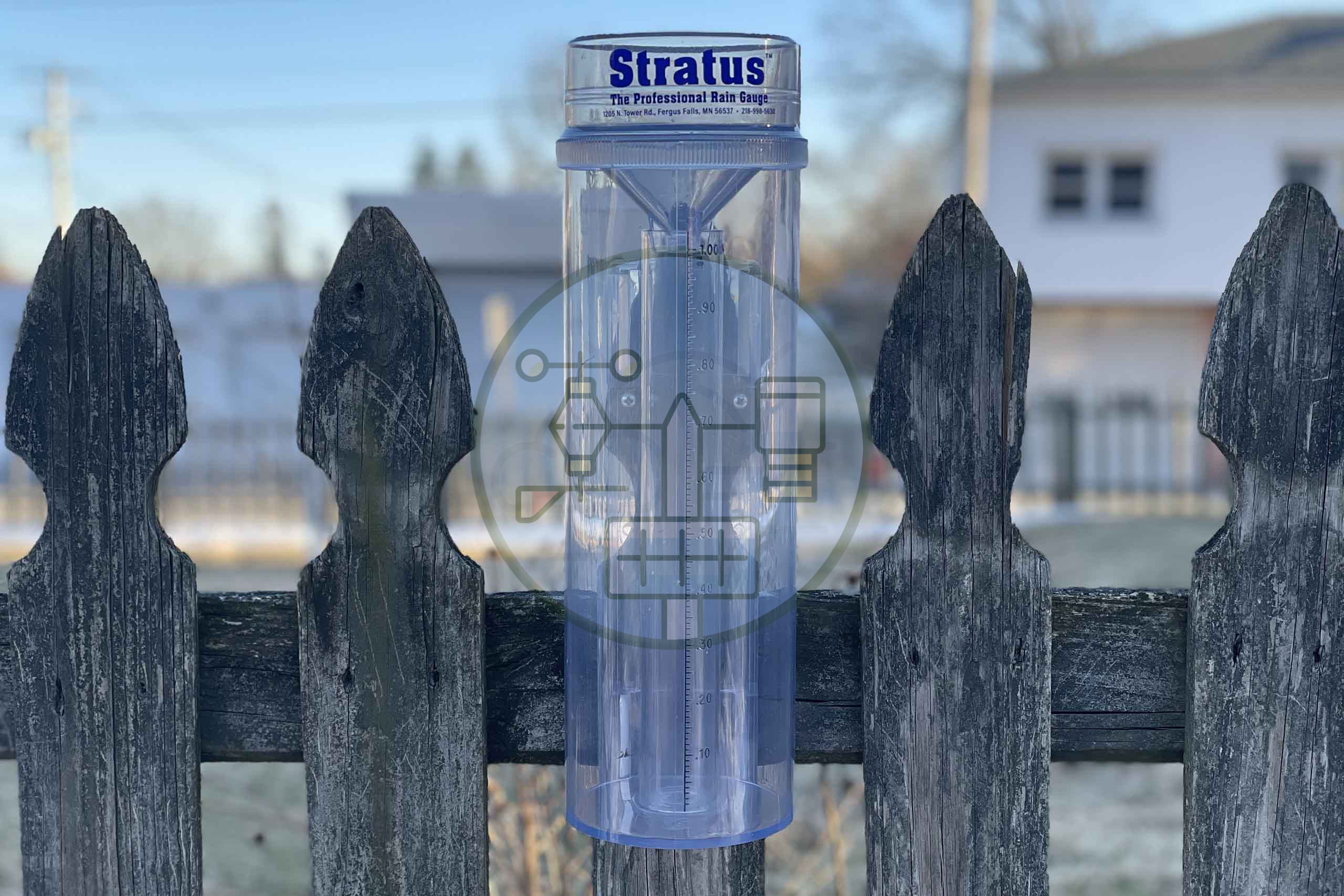 stratus rain gauge mounted on fence