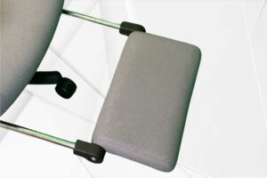 Close-up of a gray chair armrest.