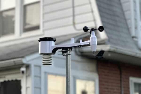 Weather station mounted on house wall.